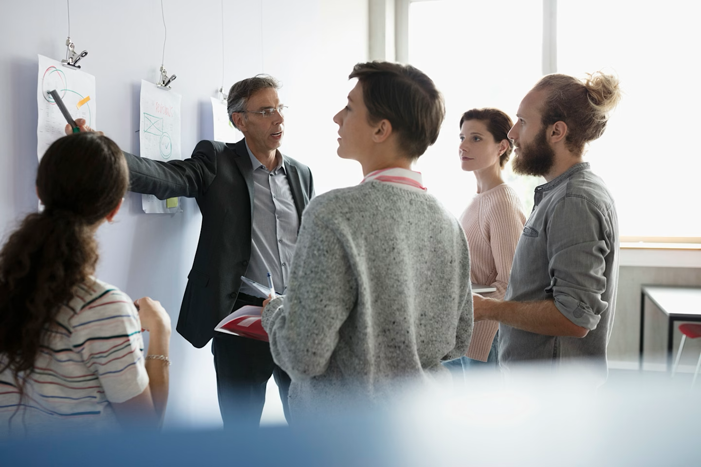 Construction team members in office meeting discussing AI adoption strategy and implementation plan